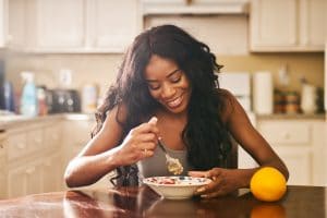 woman enjoys healthy breakfast